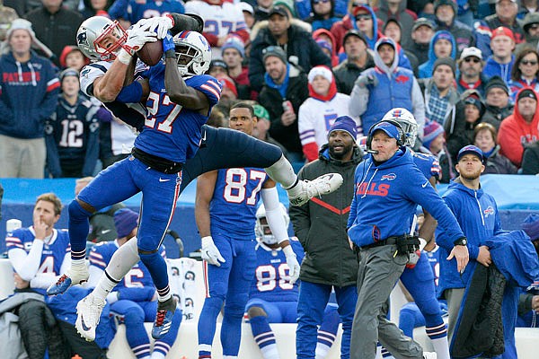 Patriots tight end Rob Gronkowski makes a catch as Bills cornerback Tre'Davious White defends during the second half of Sunday's game in Orchard Park, N.Y. Bills head coach Sean McDermott (right) looks on during the play.