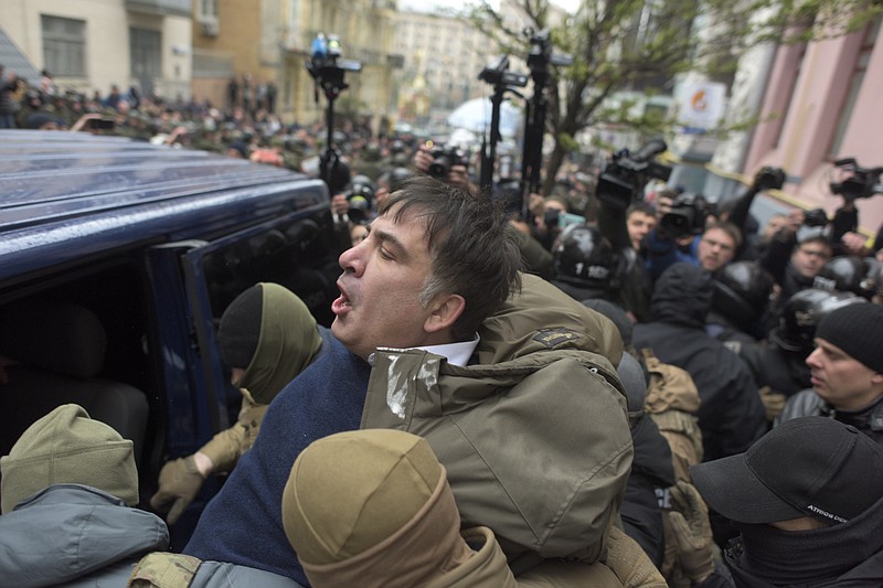 Ukrainian Security Service officers detain Mikheil Saakashvili at his house in Kiev, Ukraine, Tuesday, Dec. 5, 2017. Ukraine's intelligence agency on Tuesday detained the former president of Georgia who has emerged as an anti-corruption campaigner in his new country but faced an angry backlash of protesters who would not let the officers to take him away. (AP Photo/Evgeniy Maloletka)