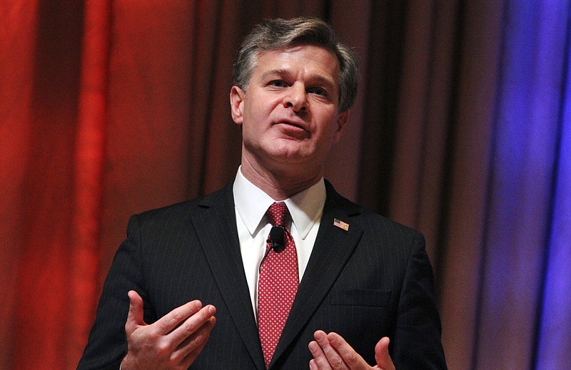 FILE - In this Oct. 22, 2017, file photo, FBI Director Christopher Wray speaks at the International Association of Chiefs of Police annual conference in Philadelphia.  Wray is facing a tough test four months into his leadership of the FBI. He must defend the agency against blistering attacks from President Donald Trump without putting his own job at risk. (AP Photo/Michael Balsamo, File)