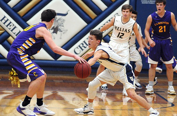 Nick Brandt of Helias reaches out for a steal during Tuesday night's game against Camdenton at Rackers Fieldhouse.