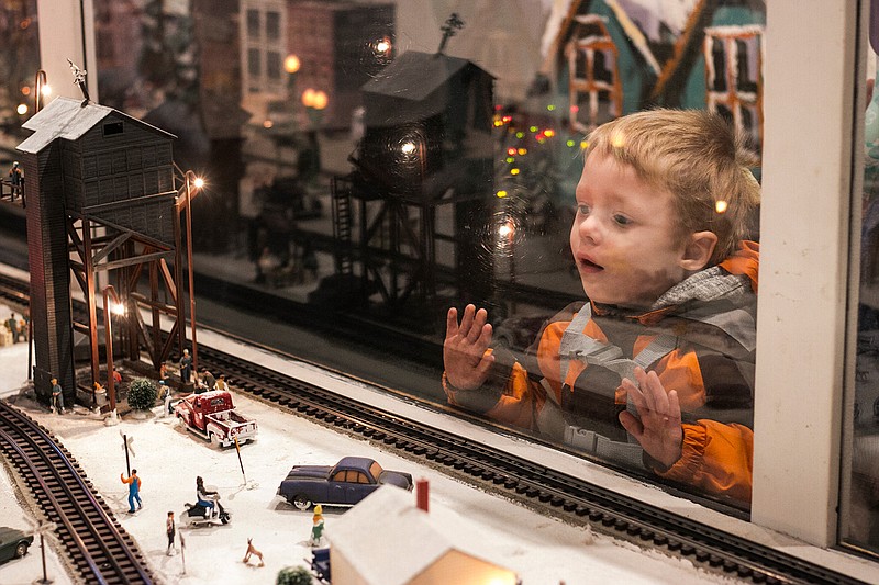 In this file photo, Lewis Ellis, 2, leans against the glass to look at model trains go by on Wednesday, Dec. 6, 2017, at the Kansas City Southern Holiday Express train. The Holiday Express stopped in Ashdown, Arkansas, to give people a taste of Christmas.