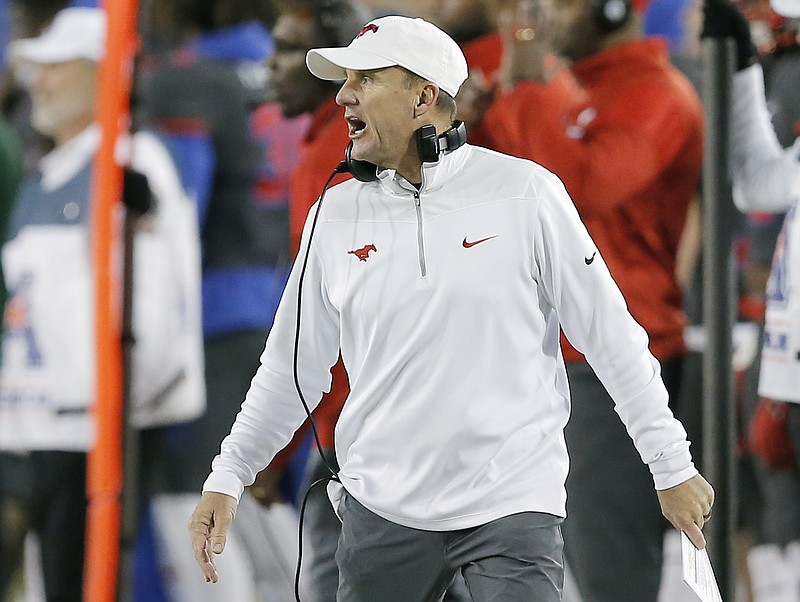 In this Nov. 19, 2016, file photo, SMU head coach Chad Morris shouts instructions from the sidelines during the first half of an NCAA college football game against  South Florida, in Dallas. A person with direct knowledge of the decision tells The Associated Press that Arkansas has hired SMU's Chad Morris to become the school's new football coach. The person spoke Tuesday night, Dec. 5, 2017, on the condition of anonymity because the decision hasn't been made public yet.