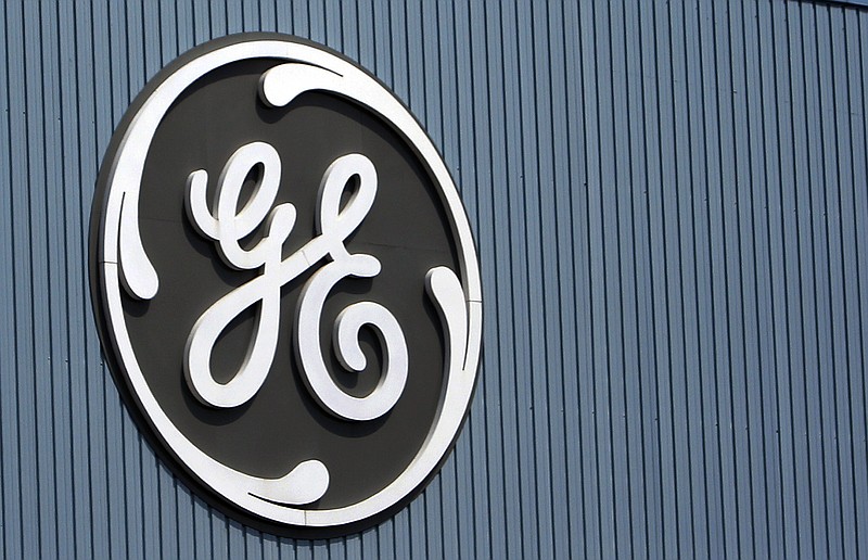 This June 24, 2014, file photo, shows the General Electric logo at a plant in Belfort, France. On Thursday, Dec. 7, 2017, GE said it will cut 12,000 jobs in its power division as alternative energy supplants demand for coal and other fossil fuels. 