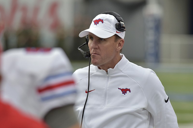 In this Nov. 18, 2017, file photo, SMU head coach Chad Morris watches from the sideline in the first half of an NCAA college football game against Memphis, in Memphis, Tenn. A person with direct knowledge of the decision tells The Associated Press that Arkansas has hired SMU's Chad Morris to become the school's new football coach. The person spoke Tuesday night, Dec. 5, 2017, on the condition of anonymity because the decision hasn't been made public yet.