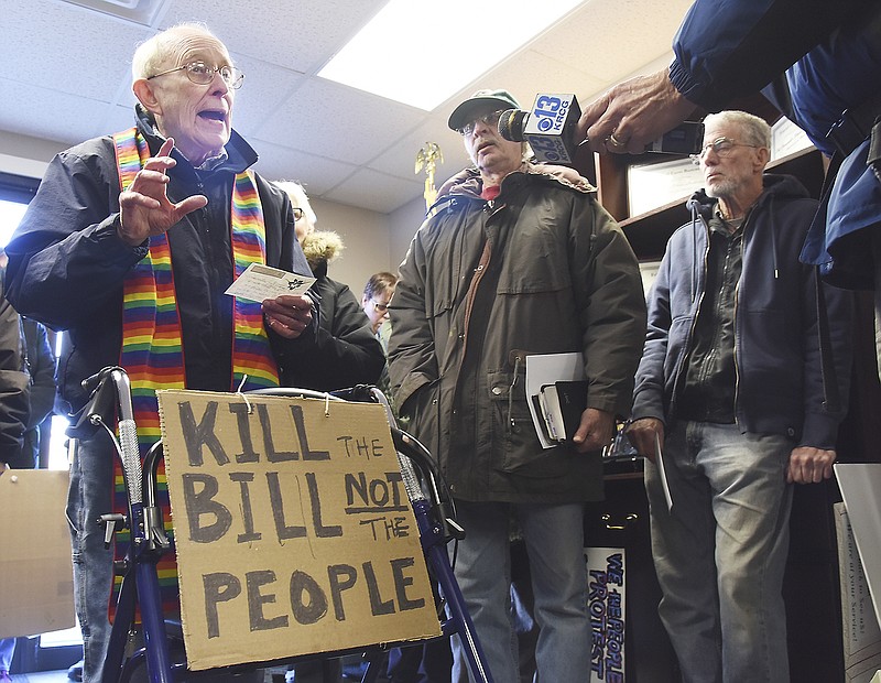 Retired Jefferson City minister the Rev. John Bennett, left, addresses staffers at U.S. Rep. Blaine Luetkemeyer's office as he several members of Jefferson City Area Indivisible gathered at the congressman's Missouri Boulevard office Thursday to speak out against the current tax proposal going through Congress. Many stated how it would negatively affect the poor and elderly and ultimately help the rich and corporations.