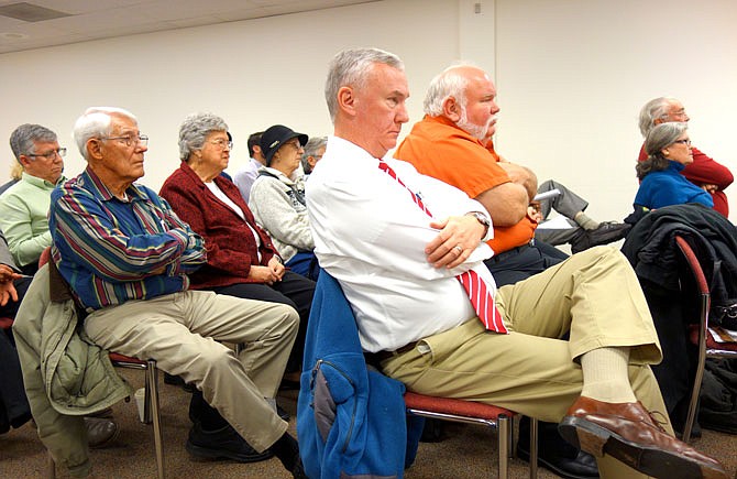 Attendees of a previous Missouri Air Conservation Commission meeting listen during the public comment period. Many members of the public offered opinions about a proposition to expand the odor rule to cover all CAFOs.