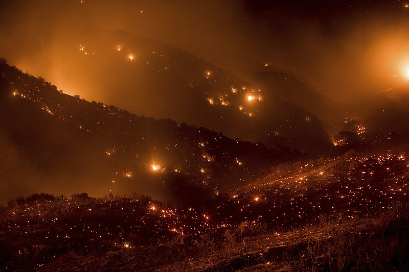 A hillside glows with embers as the Thomas fire burns through Los Padres National Forest near Ojai, Calif., on Friday, Dec. 8, 2017. (AP Photo/Noah Berger)