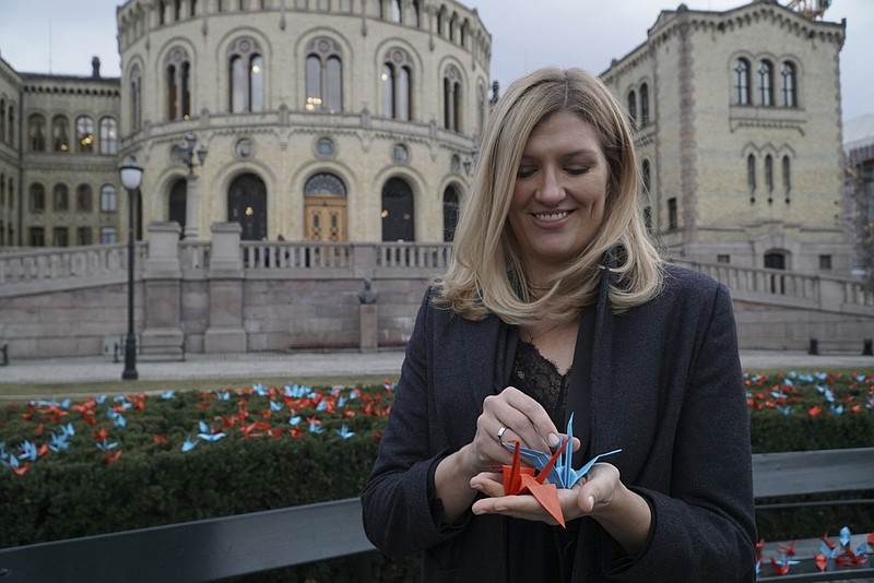 Beatrice Fihn, the executive director of the International Campaign to Abolish Nuclear Weapons (ICAN) holds two paper cranes in Oslo, Saturday, Dec. 9, 2017.  ICAN, the recipient on this year’s Nobel Peace Prize, has installed 1,000 paper cranes made by children in Hiroshima, the site of the world’s first atomic bomb attack in Japan, outside the Norwegian Parliament ahead of formally receiving the prize.(AP Photo/David Keyton)