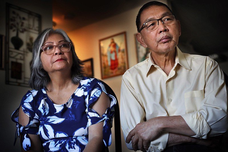 In this Friday, Dec. 1, 2017 photo, Poppy Sombah, left, and Freddy Sombah listen to an Indonesian community leader at their home in Somersworth, N.H. The couple fled Indonesia to escape harassment from their Muslim neighbors following Poppy's conversion to Christianity after marrying. After word spread earlier this year that the Indonesian community in New Hampshire faced deportation they receive unexpected support from Republican Gov. Chris Sununu. (AP Photo/Robert F. Bukaty)