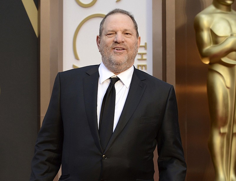 FILE - In this March 2, 2014 file photo, movie mogul Harvey Weinstein arrives at the Oscars at the Dolby Theatre in Los Angeles. Two recent lawsuits have made the unorthodox legal argument that Harvey Weinstein's pursuit of young women, and his attempts to quiet sexual assault accusations, effectively amounted to organized crime. (Photo by Jordan Strauss/Invision/AP, File)