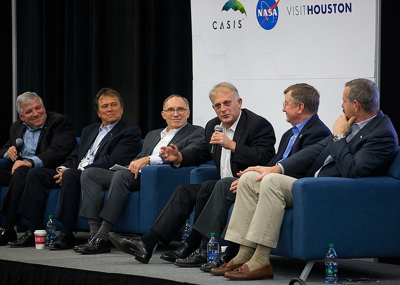 Dave Wolf, center, who made four flights to space as an astronaut, speaks as part of a panel of astronauts who have made the transition to the business world during the third annual Space Commerce Conference and Exposition, SpaceCom, Thursday, Dec. 7, 2017, in Houston.