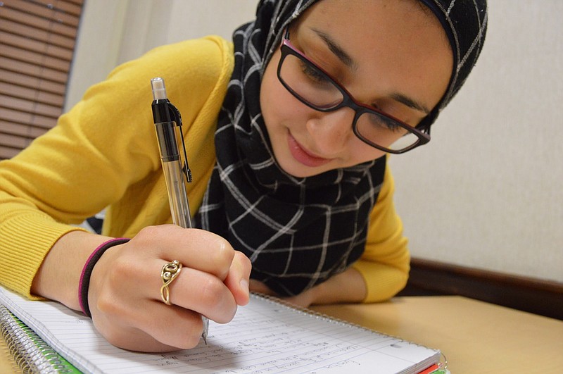 Tasneem Essader studies at a residence hall at the University of North Carolina in Chapel Hill, N.C., on Dec. 2, 2017. The Adawia Alousi Scholars program, a scholarship for Muslim women pursuing careers in science, technology, engineering and math with money from Alousi's family trust, is believed to be the first of its kind. The inaugural class of 11 recipients includes refugees, daughters of poor parents and the first in their families to go to college. (Gabriel Lima via AP)