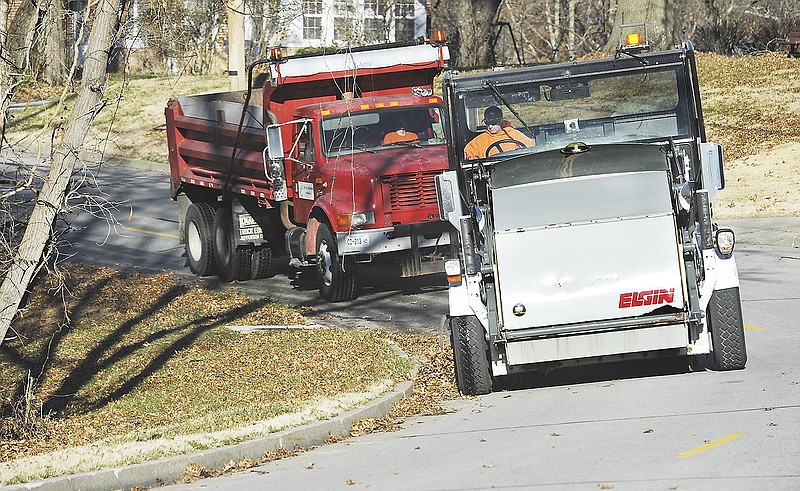 John Reutter of the Jefferson City Streets Department operates the street sweeper Friday on St. Louis Road ridding the curb and gutter of leaves to prevent later clogging street drains. After filling the hopper, Reutter then dumps it into a dumptruck to be hauled away. Residents are asked to not blow them in the streets so as to prevent issues with the sweepers performing their assigned tasks. 