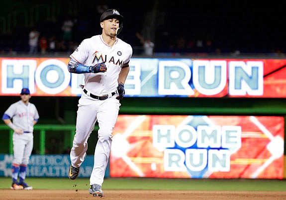 Giancarlo Stanton of the Marlins runs the bases after hitting a three-run home run during a game last season against the Mets in Miami.