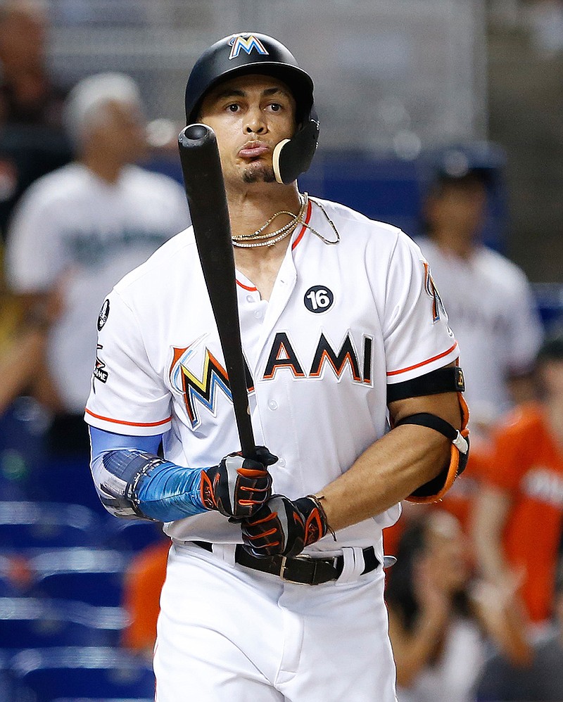 In this Thursday, Aug. 31, 2017 file photo, Miami Marlins' Giancarlo Stanton reacts after he flies out during the ninth inning of a baseball game against the Philadelphia Phillies in Miami. Giants general manager Bobby Evans confirmed on San Francisco's flagship radio station KNBR that the club has reached the parameters of a trade for Miami slugger Giancarlo Stanton. Evans spoke Wednesday, Dec. 6, 2017 of the Giants' pursuit of the Marlins star.