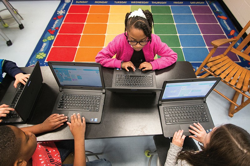 Ceylon Grissom, 10, Amari Shaw, 10, and Lilly Corbin, 9, participate in Hour of Code on Wednesday at Fairview Elementary School. The Hour of Code is a one-hour introductory class to computer science designed to get children involved with learning how to code. 