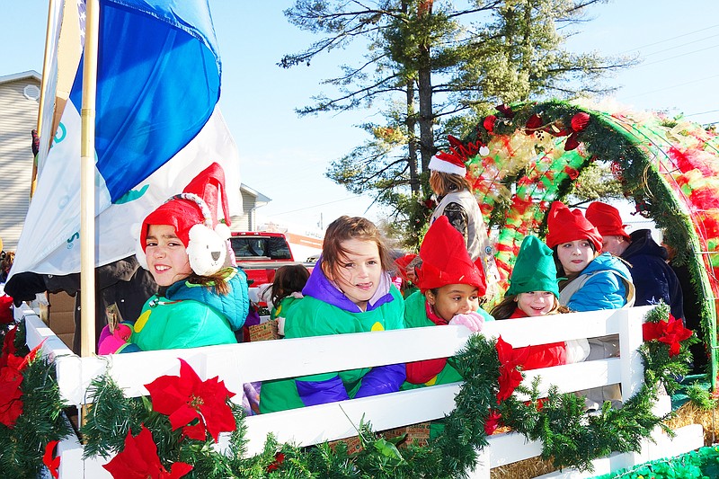 Members of a the Holts Summit Girl Scout troop wave from a float in the Holts Summit Christmas parade on Dec. 9, 2017.