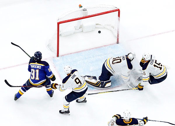 Blues right wing Vladimir Tarasenko (left) scores the game-winning goal past Sabres goalie Robin Lehner as the Sabres' Evander Kane (9) and Jack Eichel (15) defend during overtime of Sunday night's game in St. Louis. The Blues won 3-2 in overtime.