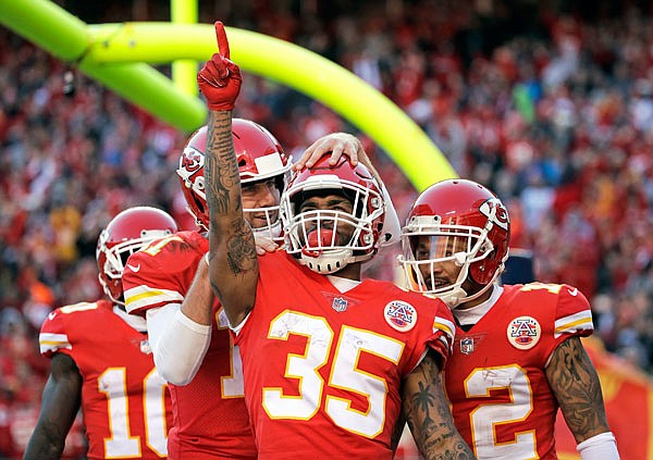 Chiefs running back Charcandrick West celebrates his touchdown against the Raiders with quarterback Alex Smith (left) and wide receiver Albert Wilson during the second half of Sunday afternoon's game at Arrowhead Stadium in Kansas City.