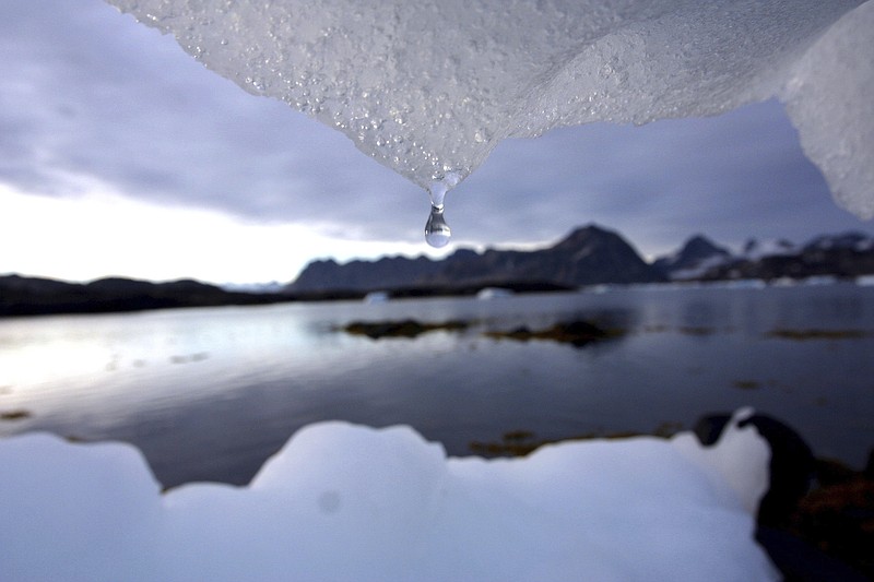 FILE - In an Aug, 16, 2005 file photo, an iceberg melts in Kulusuk, Greenland near the arctic circle. A new report finds permafrost in the Arctic is thawing faster than ever before. The annual report card released Tuesday, Dec. 12, 2017, also finds water is warming and sea ice is melting at the fastest pace in 1,500 years at the top of the world. (AP Photo/John McConnico, File)