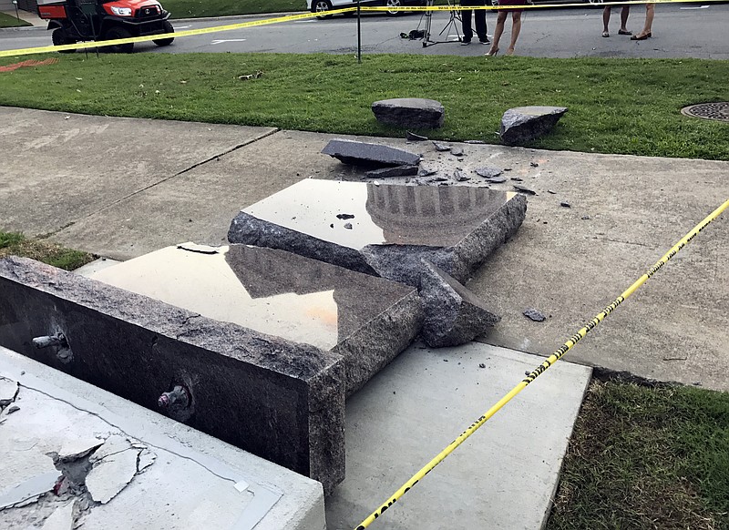FILE - In this June 28, 2017, file photo, a Ten Commandments monument outside the state Capitol in Little Rock, Ark., is blocked off after a man crashed into it with a vehicle, less than 24 hours after the privately funded monument was installed on the Capitol grounds. The Arkansas Capitol Arts and Grounds Commission signed off on the final design Tuesday, Dec. 12, 2017, for a new monument, which will now include four concrete posts for protection. (AP Photo/Jill Zeman Bleed, File)