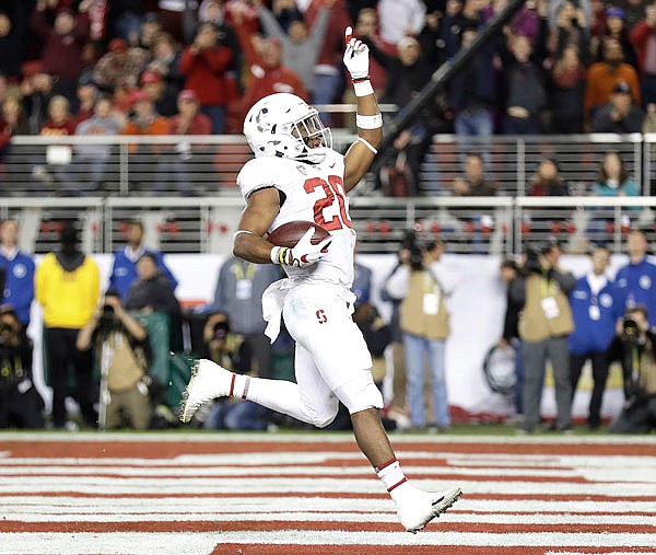 Stanford running back Bryce Love celebrates after scoring a touchdown against USC during the first half of the Pac-12 Conference championship game earlier this month in Santa Clara, Calif. Love, who was the runner-up for the Heisman Trophy, was named to the AP All-America first team Monday.