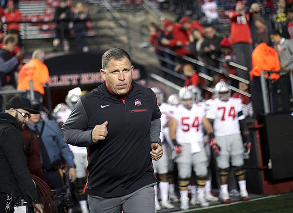 Ohio State associate head coach Greg Schiano runs onto the field before a game against Rutgers earlier this season in Piscataway, N.J.