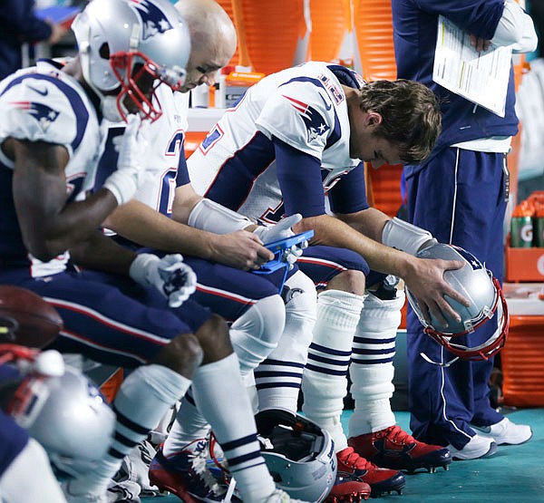 Patriots quarterback Tom Brady sits on the bench during the end of the second half in Monday night's game against the Dolphins in Miami Gardens, Fla. The Dolphins defeated the Patriots 27-20.