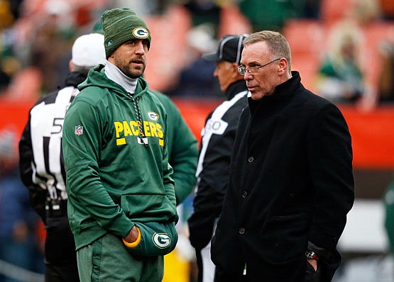 Packers quarterback Aaron Rodgers talks with Browns general manager John Dorsey before Sunday's game in Cleveland.