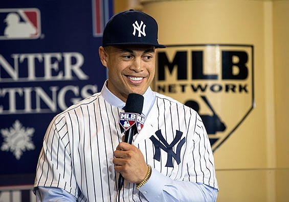 Giancarlo Stanton answers questions during a press conference Monday at the Major League Baseball winter meetings in Orlando, Fla.