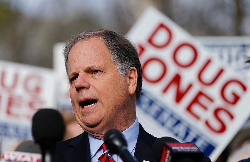 Democratic candidate for U.S. Senate Doug Jones speaks to reporters after casting his ballot Tuesday, Dec. 12, 2017, in Mountain Brook , Ala. 