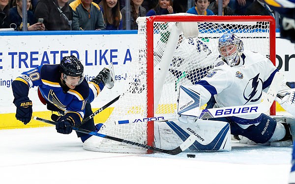 Brayden Schenn of the Blues tries to push the puck past Lightning goalie Andrei Vasilevskiy during the second period of Tuesday night's game in St. Louis.