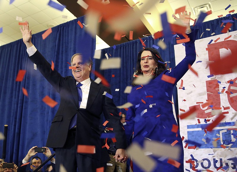 Democratic candidate for U.S. Senate Doug Jones and his wife Louise wave to supporters before speaking during an election-night watch party Tuesday, Dec. 12, 2017, in Birmingham, Ala. In a stunning victory aided by scandal, Democrat Doug Jones won Alabama's special Senate election on Tuesday, beating back history, an embattled Republican opponent and President Donald Trump, who urgently endorsed GOP rebel Roy Moore despite a litany of sexual misconduct allegations. (John Bazemore)