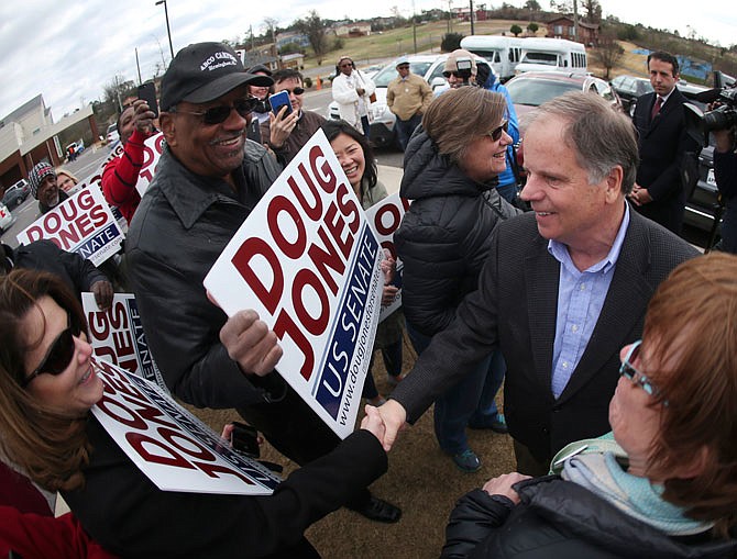 Democratic candidate for U.S. Senate Doug Jones greets supporters and voters Tuesday outside Bethal Baptist Church  in Birmingham, Alabama. Jones beat Republican Roy Moore for the seat.