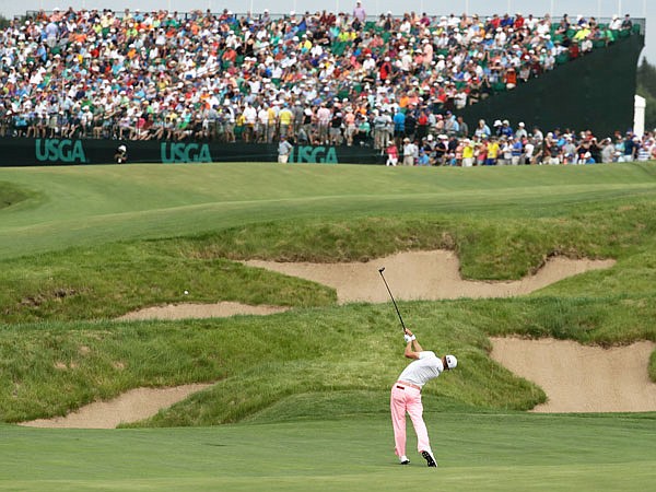 In this June 17 file photo, Justin Thomas hits to the 18th green during the third round of the U.S. Open at Erin Hills in Erin, Wis.