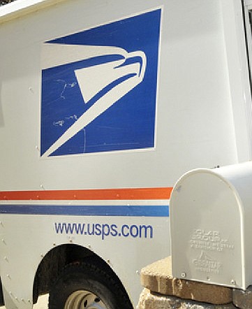 A U.S. Postal Service truck delivers mail.