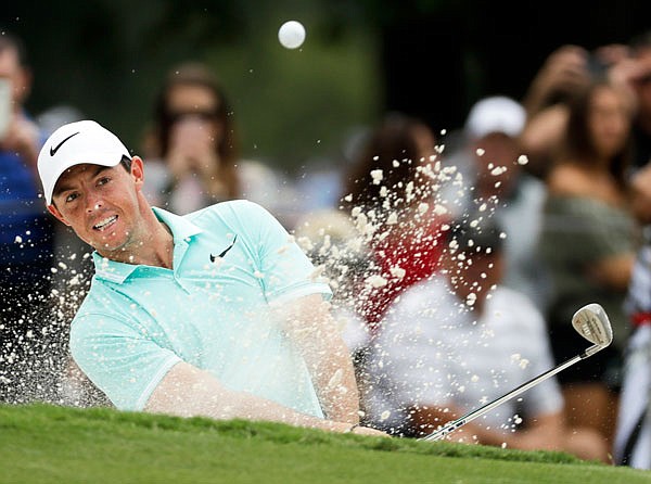In this Aug. 9 file photo, Rory McIlroy hits from the bunker on the ninth hole during a practice round at the PGA Championship at the Quail Hollow Club, in Charlotte, N.C.