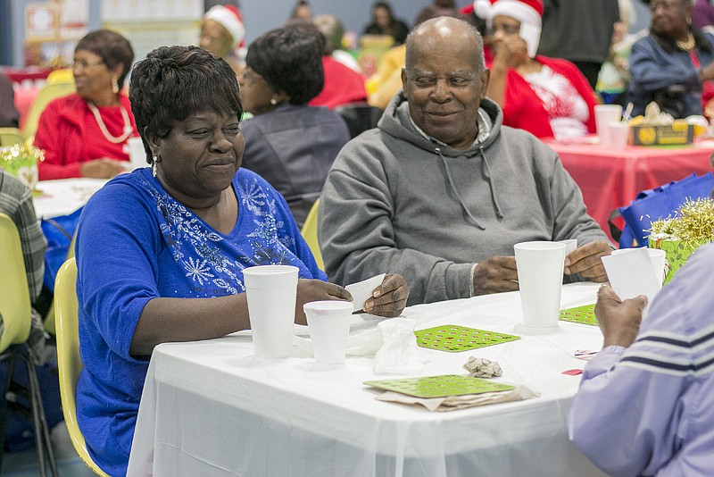 Laura Spencer and Roosevelt Agent play a game for door prizes Wednesday at the Southwest Community Center. The center had a Seniors Day Out Holiday Celebration complete with games and gifts.
