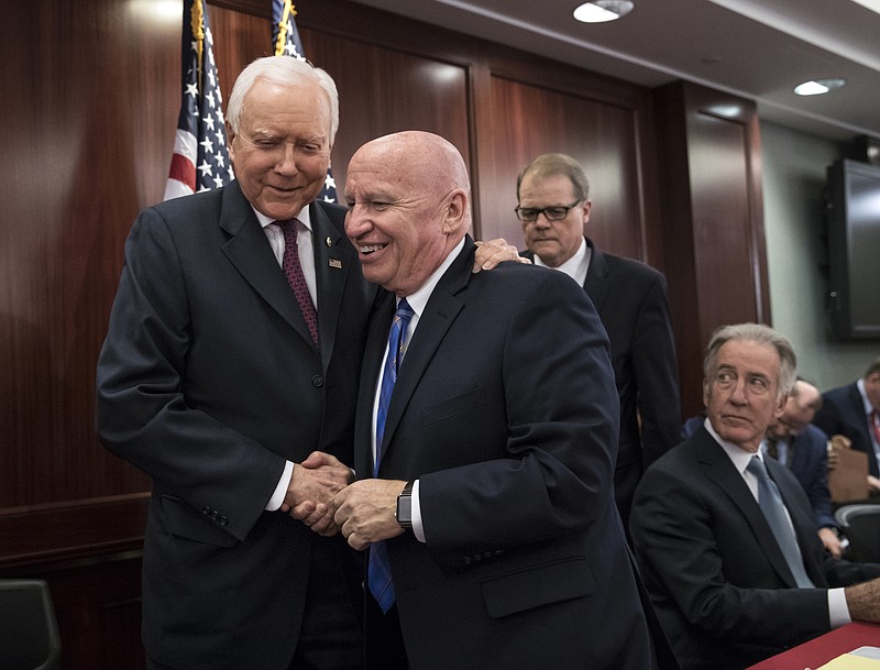 Senate Finance Committee Chairman Orrin Hatch, R-Utah, left, embraces House Ways and Means Committee Chairman Kevin Brady, R-Texas, on Wednesday, Dec. 13, 2017, after GOP leaders announced they have forged an agreement on a sweeping overhaul of the nation's tax laws, on Capitol Hill in Washington.