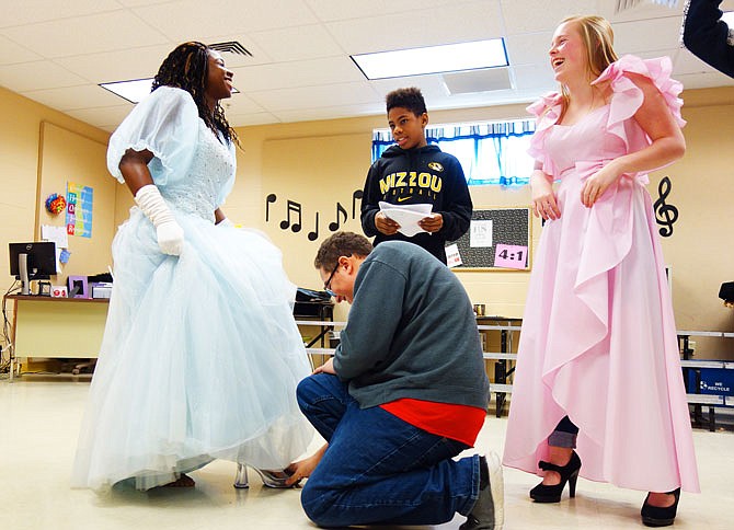 Prince Charming (Danté Helming, kneeling) helps Cinderella (Kiah Pittman, left) put on her glass slipper while she shares a laugh with Prince Martin (Mavrik Schor) and Sleeping Beauty (Samantha Cooke). The class will perform their original musical, "The Untold Story," on Monday.