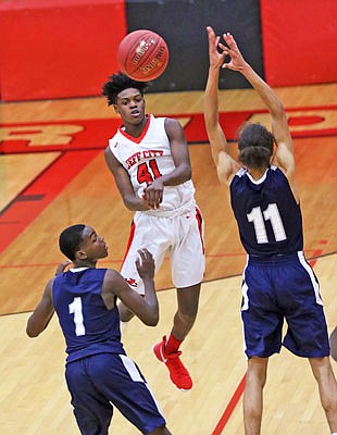 Jared Cooper of the Jays makes a pass past Rayonte Childs (1) and Javon Bolden (11) of Northwest Academy of Law during a Dec. 1 game at Fleming Fieldhouse.