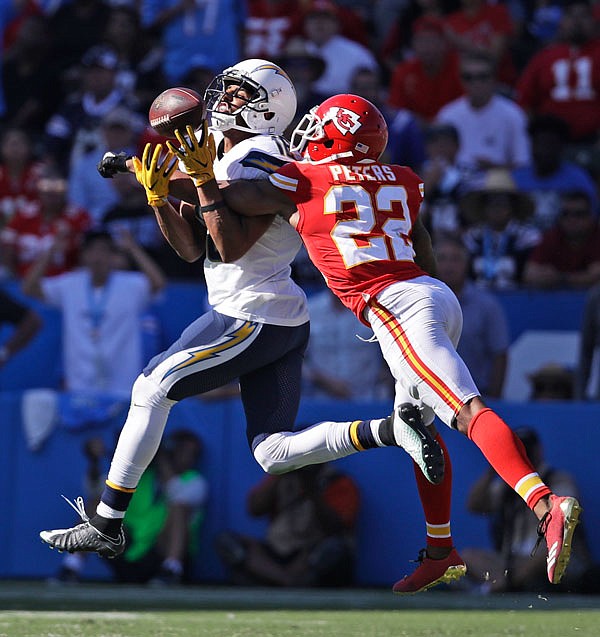 In this Sept. 24 file photo, Chiefs cornerback Marcus Peters (right) breaks up a pass intended for Chargers wide receiver Tyrell Williams during a game in Carson, Calif.
