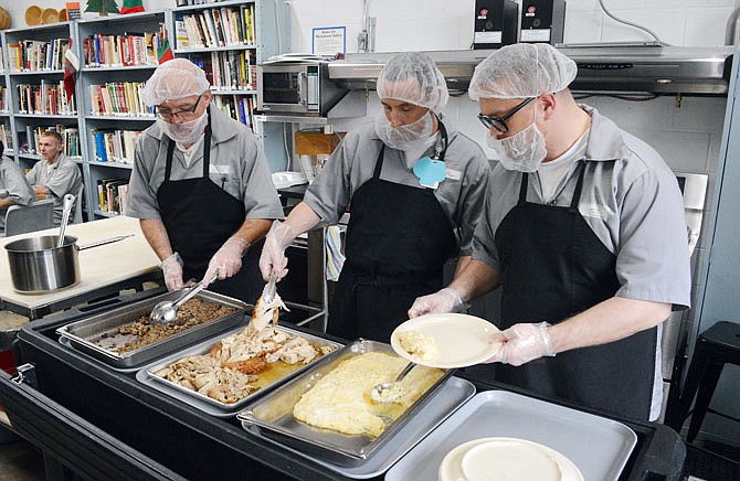 Culinary arts program students, from left, Ben Piercy, Billy Boyd and Ryan Shute prepare a meal for visitors Thursday at the Algoa Correctional Center.
