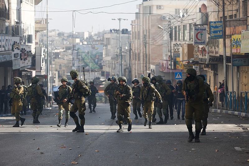 Israeli soldiers deploy doing clashes with Palestinians following a protest against U.S. President Donald Trump's decision to recognize Jerusalem as the capital of Israel in the West Bank city of Hebron, Friday, Dec. 15, 2017.