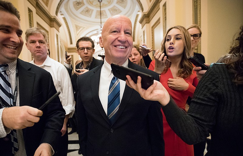 House Ways and Means Committee Chairman Kevin Brady, R-Texas, is pursued by reporters in the Capitol after signing the conference committee report to advance the GOP tax bill, in Washington, Friday, Dec. 15, 2017.