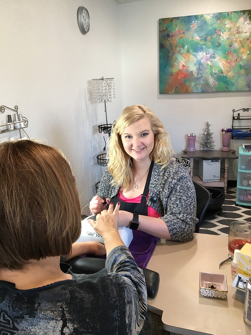 <p>Submitted photo</p><p>Nail technician Carrie Call takes care of a client in the expanded salon at Something Sassy.</p>