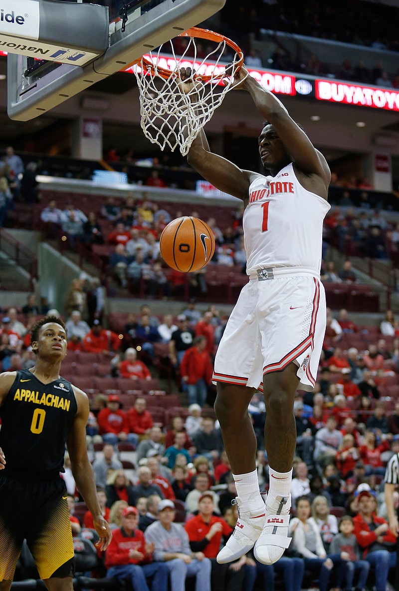 Ohio State forward Jae'Sean Tate, right, dunks against Appalachian State forward Isaac Johnson during the first half of an NCAA college basketball game in Columbus, Ohio, Saturday, Dec. 16, 2017. 