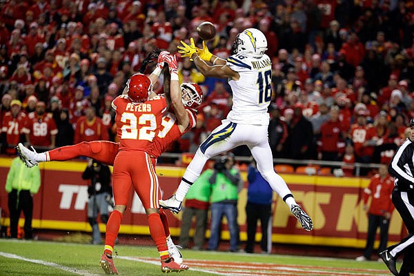 Chargers wide receiver Tyrell Williams can't hold on to the ball against Chiefs defensive backs Marcus Peters and Daniel Sorensen during the first half of Saturday night's game at Arrowhead Stadium.