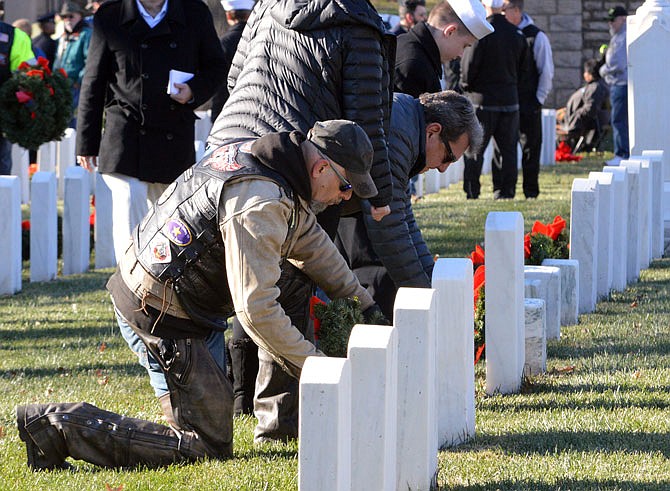 Wreaths are placed on the graves of veterans buried at the National Cemetery during a past Wreaths for Heroes event.