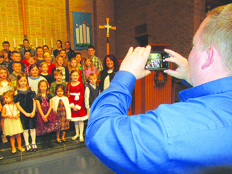 Mike Zielinski, a Sunday school teacher at Faith Lutheran Church, takes a photo of the students Sunday morning after they raised $300 to send a military veteran on a Central Missouri Honor Flight.